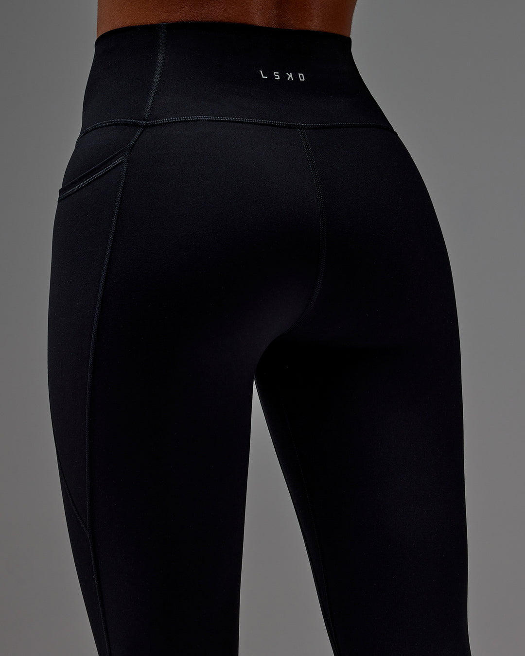 Woman wearing Fusion 3/4 Length Tight with Pockets in Black | Model:Txai | Size:XS