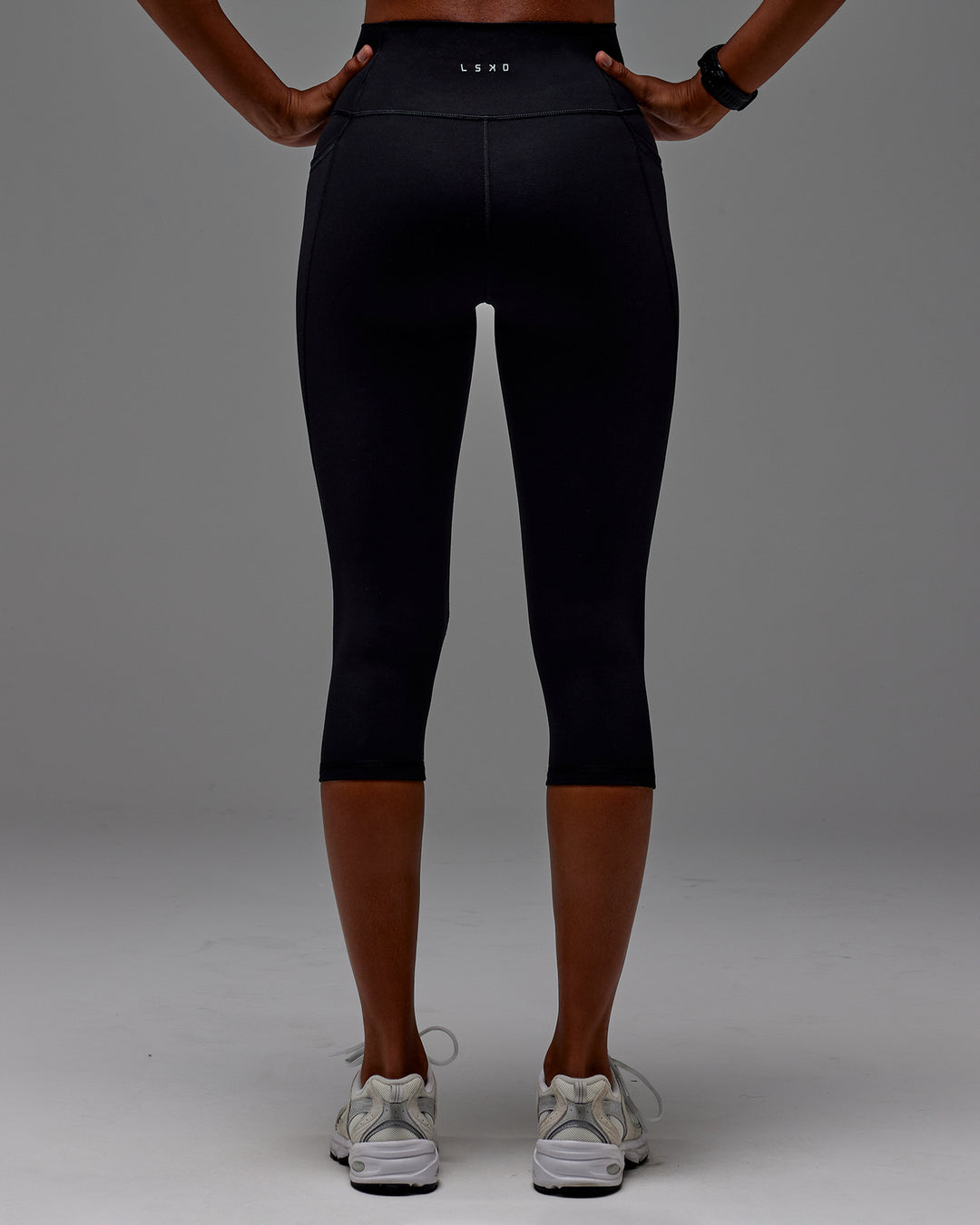 Woman wearing Fusion 3/4 Length Tight with Pockets in Black | Model:Txai | Size:XS