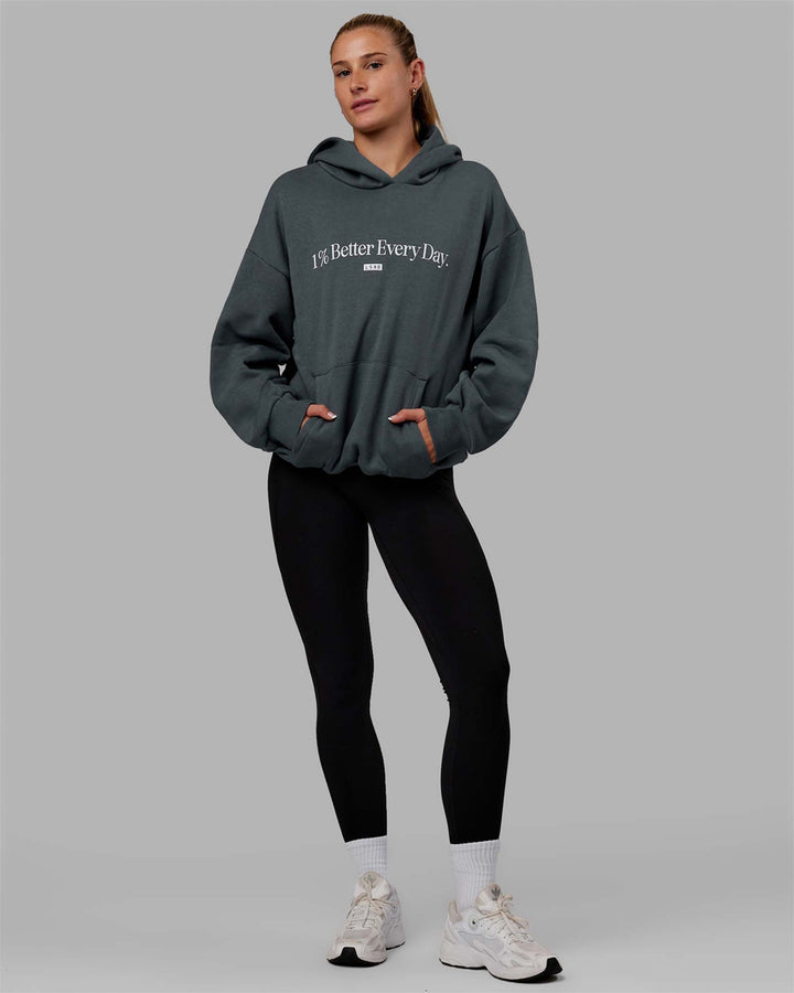 Woman wearing Unisex 1% Better Hoodie Oversize - Storm-White
