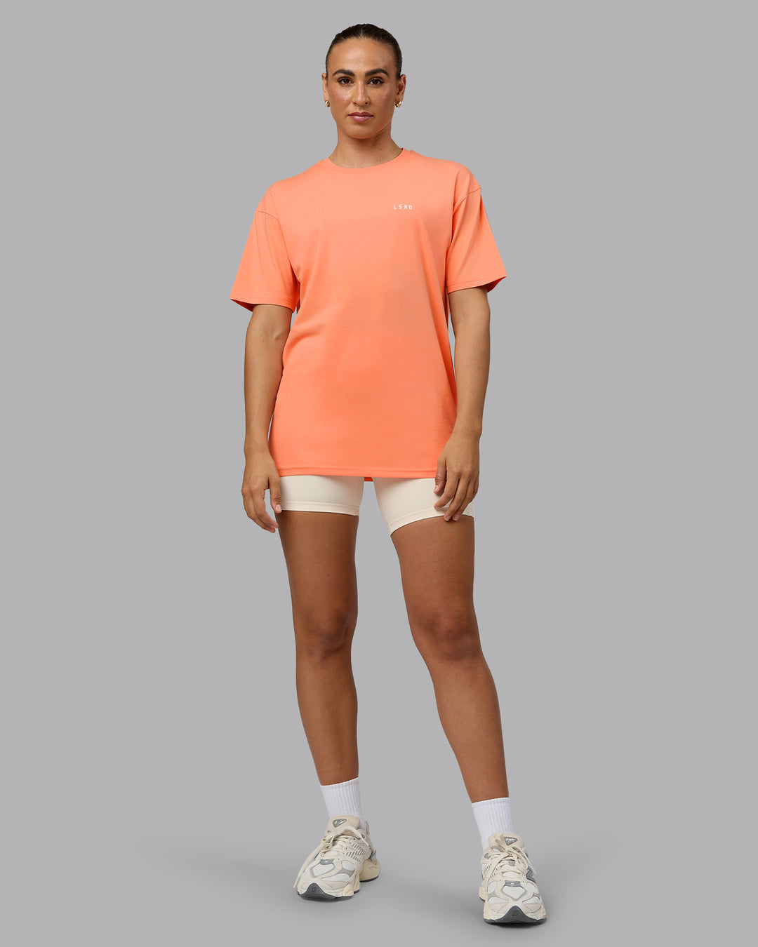 Woman wearing Unisex 1% Better Value Series FLXCotton Tee Oversize - Mellow Peach-White