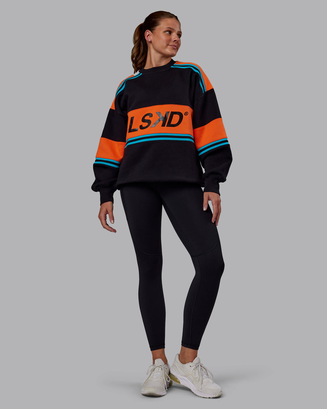 Woman wearing A-Team Sweater Oversize - Black-Ultra Orange | Model:Phoebe | Size:XS