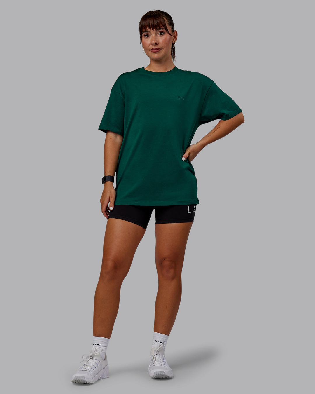 Woman wearing Unisex Deluxe PimaFLX Tee Oversize - Deep Emerald