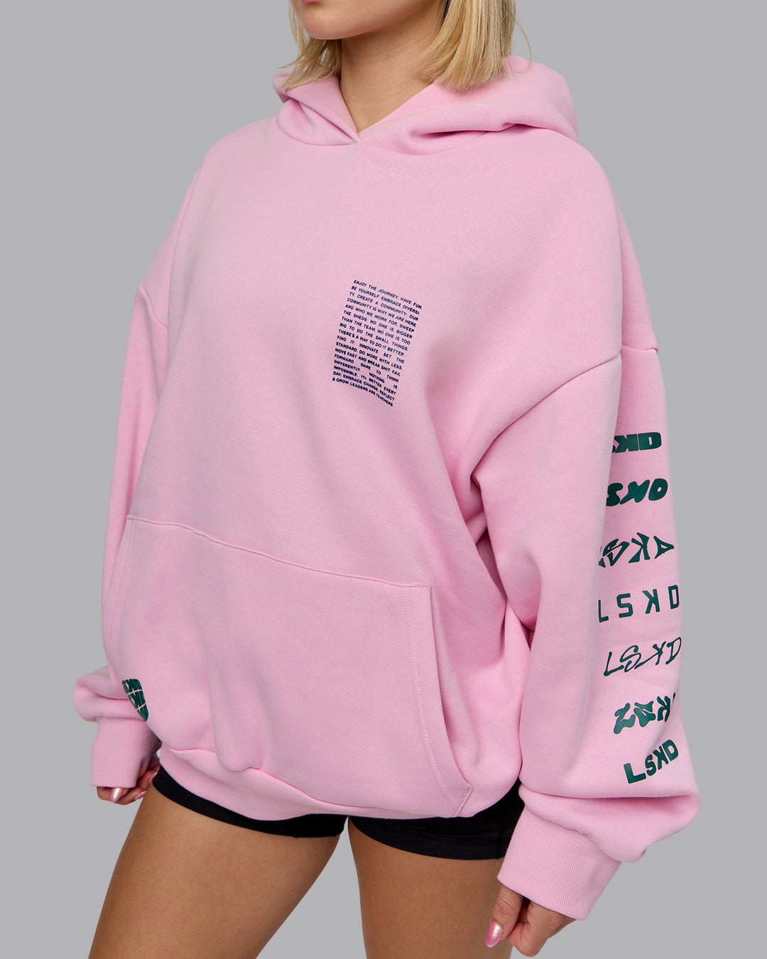 Woman wearing Displacement Oversized Hoodie - Light Bubblegum-Dark Moss | Model:Halle | Size:XS