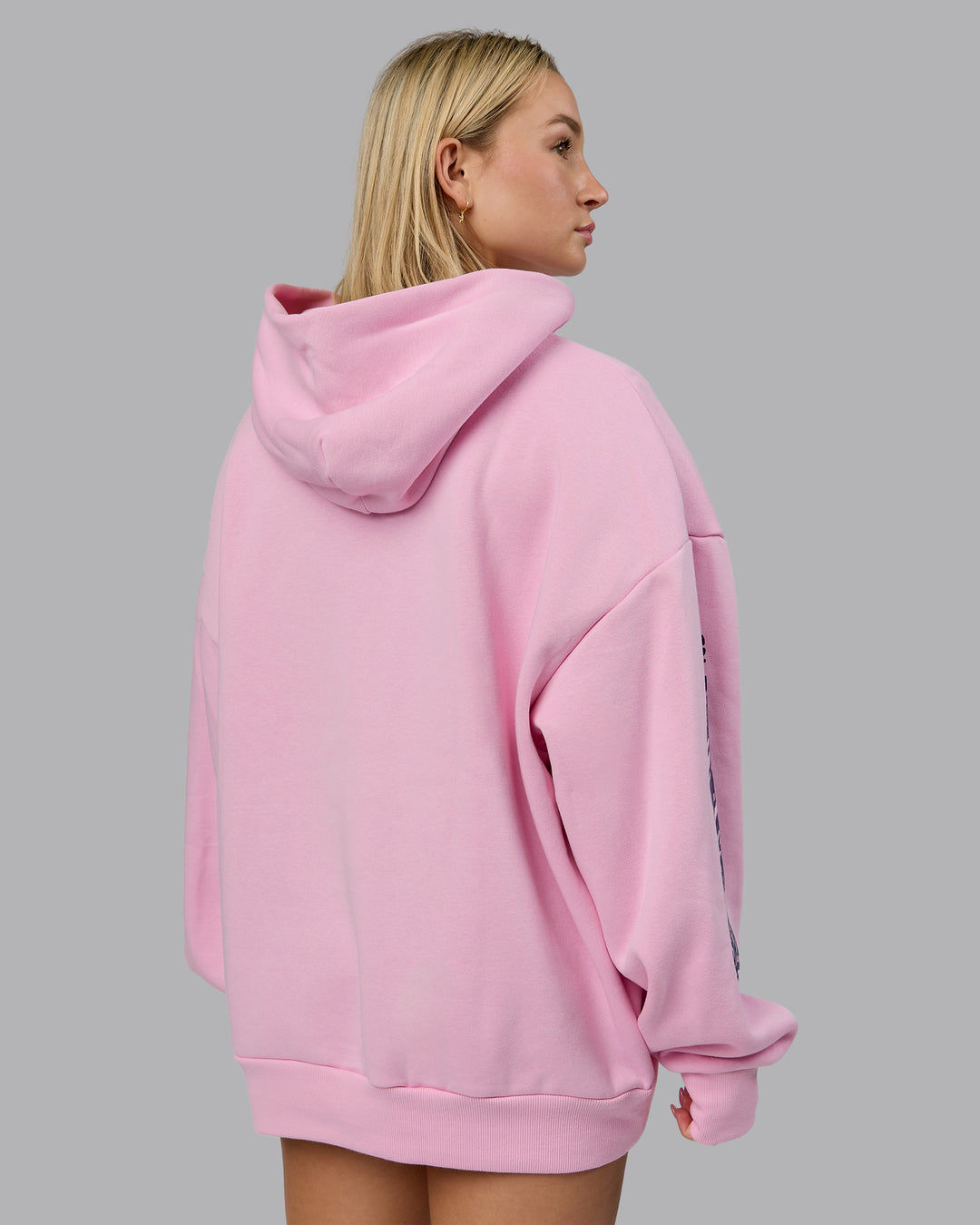 Woman wearing Displacement Oversized Hoodie - Light Bubblegum-Dark Moss | Model:Halle | Size:XS