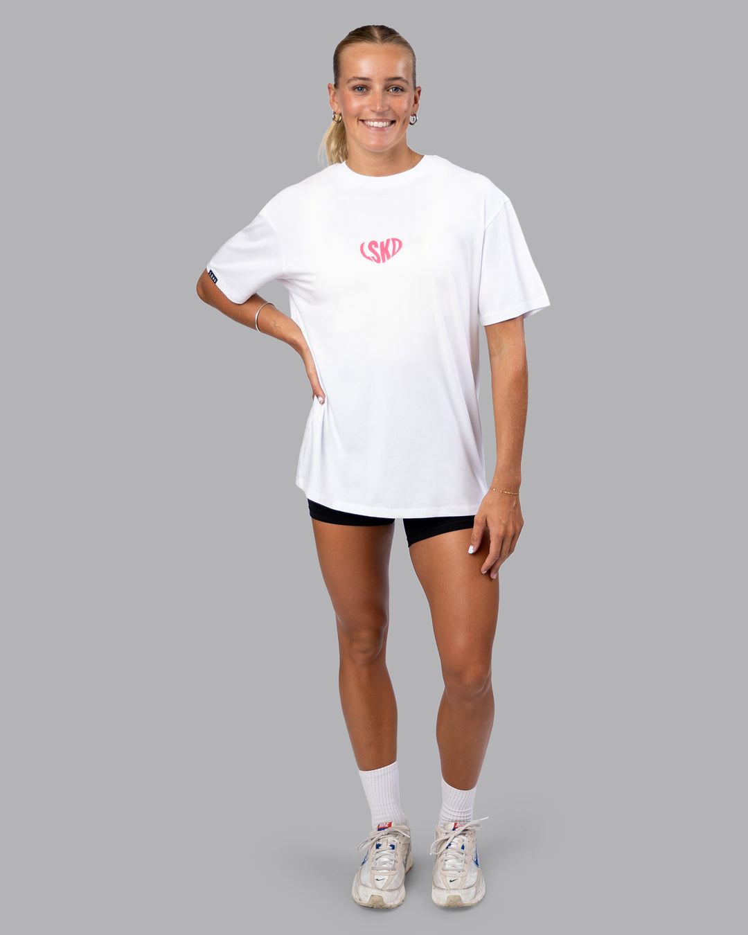 Woman wearing Unisex Love To Train FLXCotton Tee Oversize - White-Pink Lemonade | Size:XS