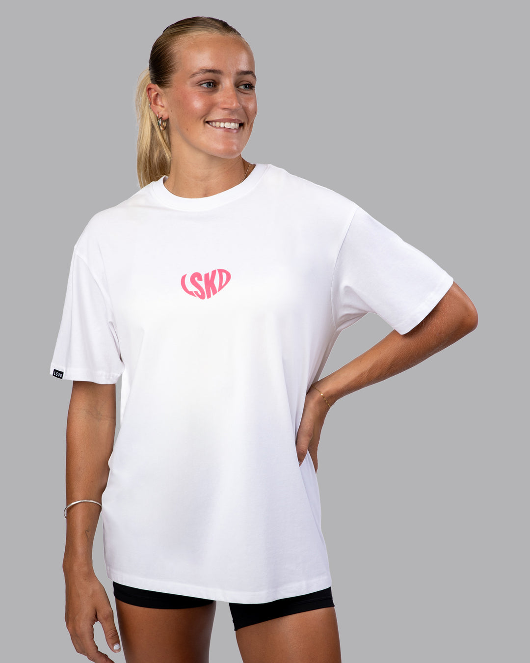 Woman wearing Unisex Love To Train FLXCotton Tee Oversize - White-Pink Lemonade | Size:XS