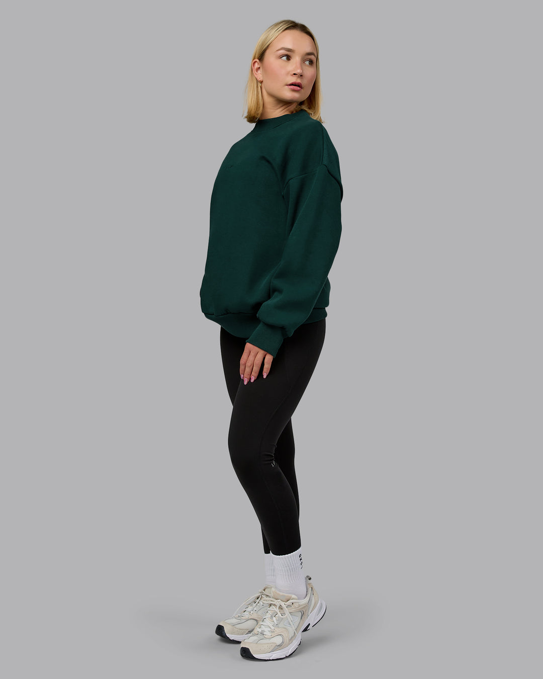 Woman wearing MVP Oversized Sweater in Dark Moss | Size:XS | Model:Halle