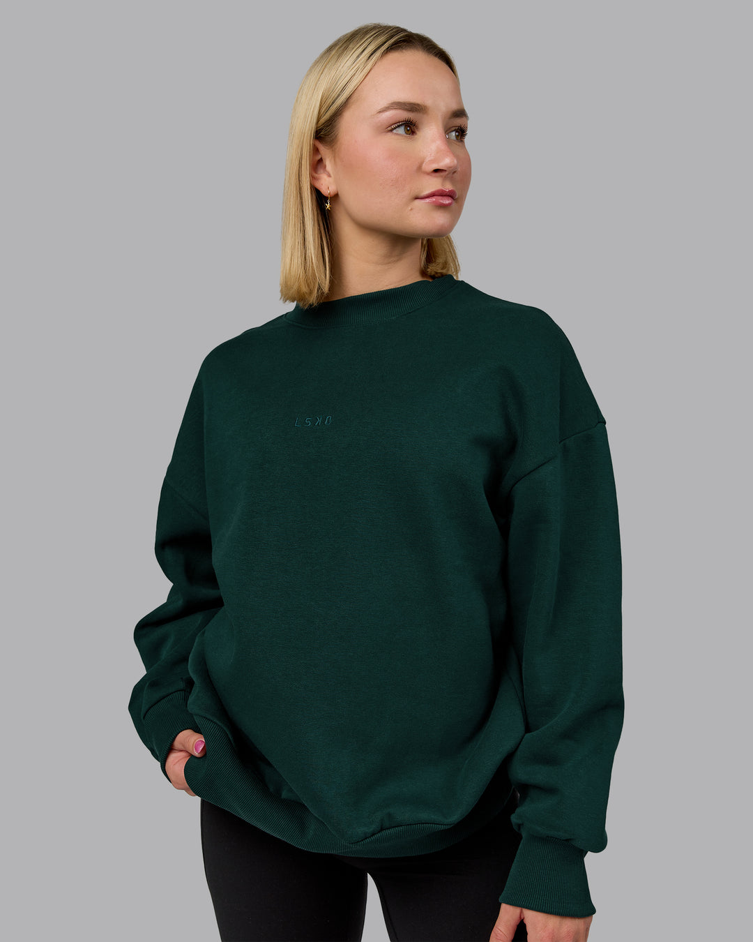 Woman wearing MVP Oversized Sweater in Dark Moss | Size:XS | Model:Halle