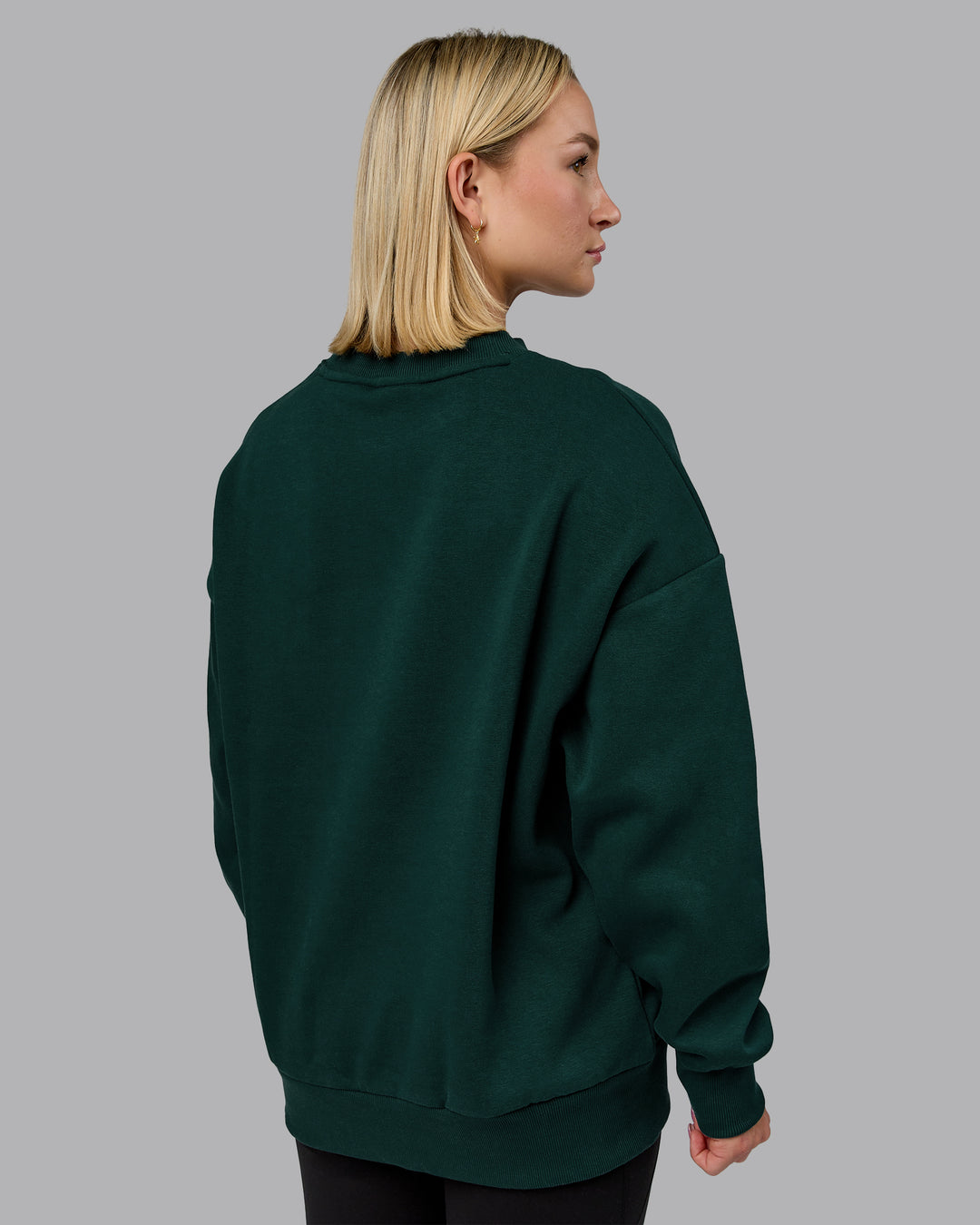 Woman wearing MVP Oversized Sweater in Dark Moss | Size:XS | Model:Halle