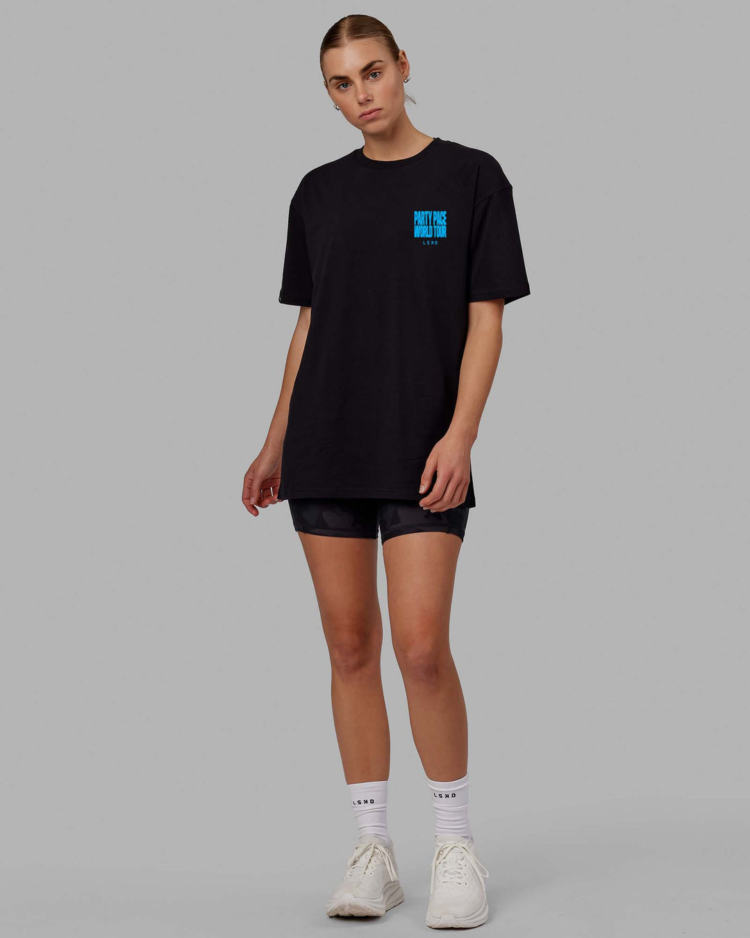 Woman wearing Unisex Party Pace FLXCotton Oversize Tee - Black-Blue