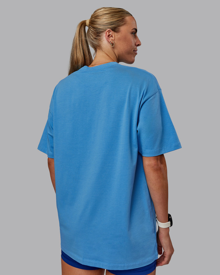 Woman wearing Unisex PimaFLX Tee Oversize in Azure Blue | Size:XS
