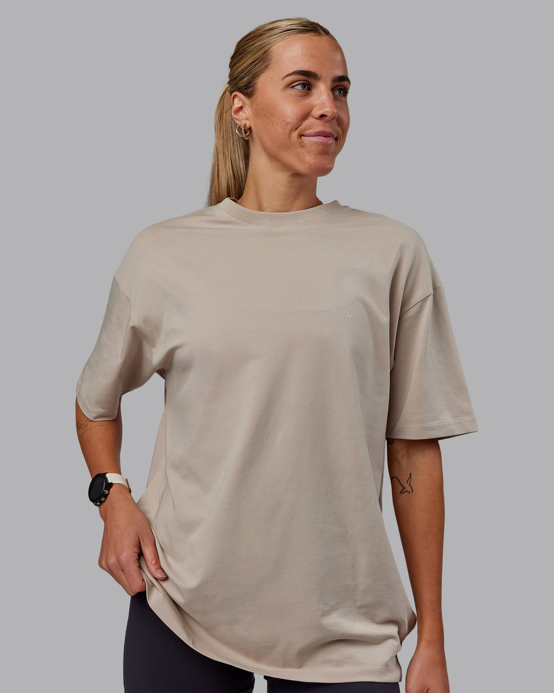 Woman wearing Unisex PimaFLX Tee Oversize in Shale Beige | Size:XS