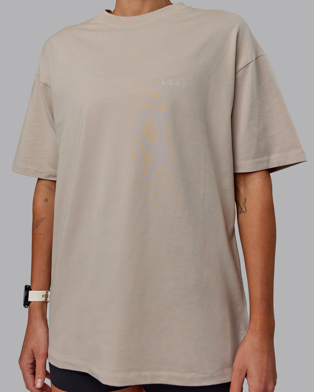 Woman wearing Unisex PimaFLX Tee Oversize in Shale Beige | Size:XS