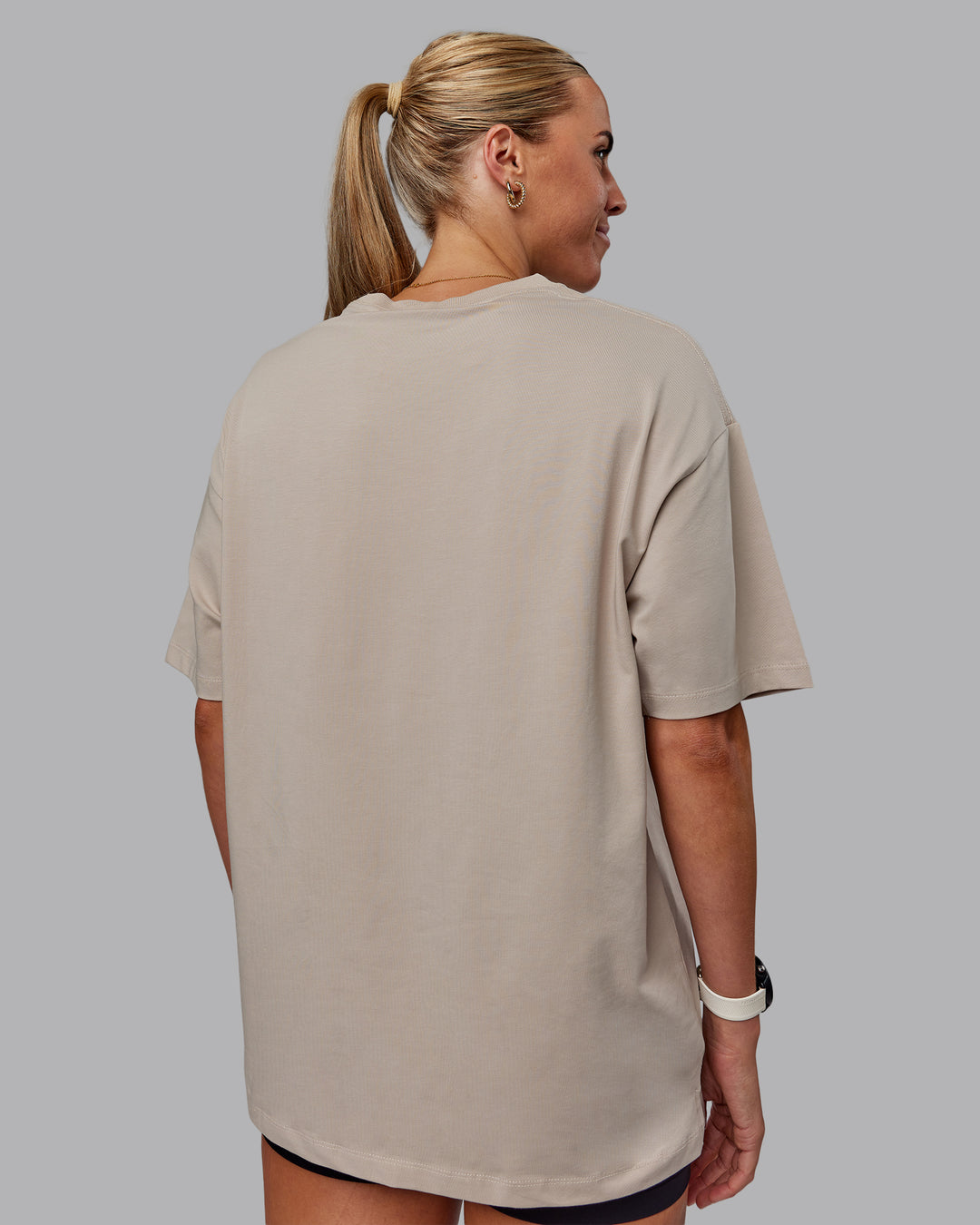 Woman wearing Unisex PimaFLX Tee Oversize in Shale Beige | Size:XS