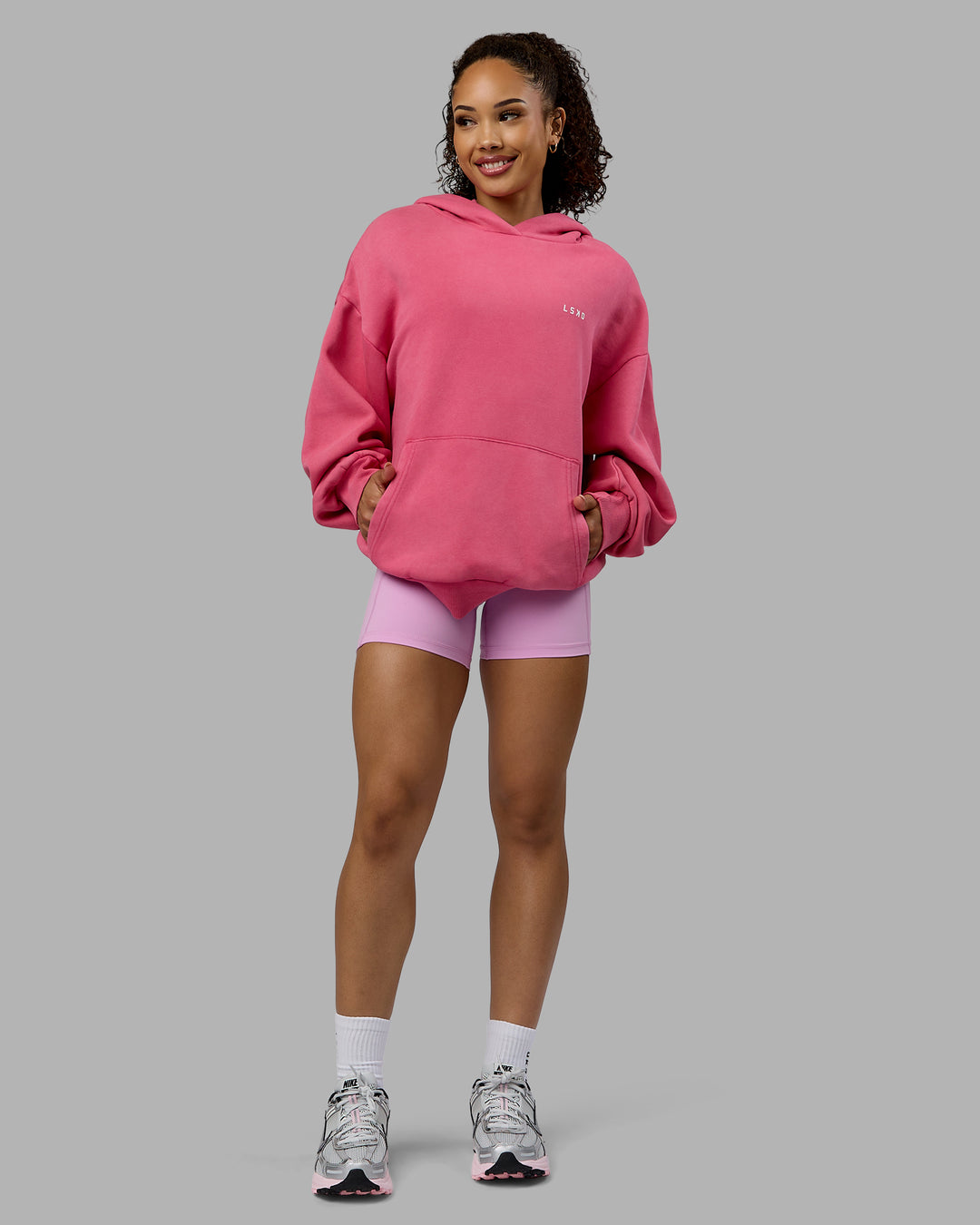 Woman wearing Unisex Washed Empower Hoodie Oversize - Berry Pink-Pastel Orchid