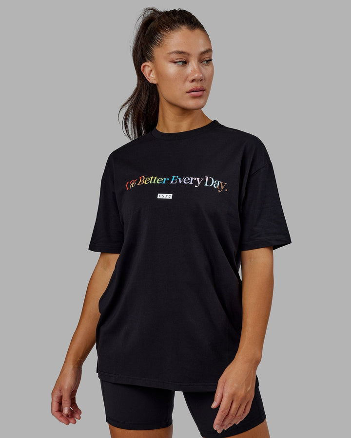 Woman wearing Unisex 1% Better FLXCotton Tee Oversize - Pride-Black
